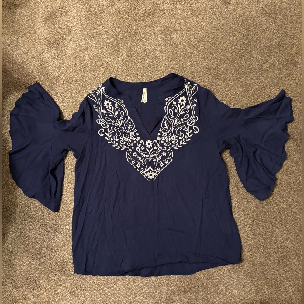 Ladies Roper blue v-neck shirt with ruffle sleeves and white neckline stitching.